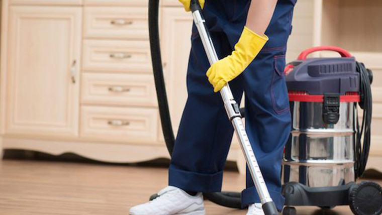 office boy cleaning the floor